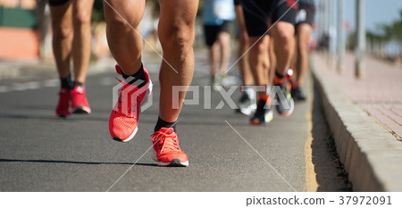 Marathon running in the light of evening Marathon running in the light of evening 37972091
