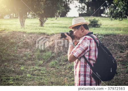 Older man backpacking travel are taking photo Older man backpacking travel are taking photo 37972563
