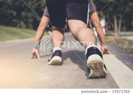 Close up on shoes, athlete runner feet running on track to begin 37972568