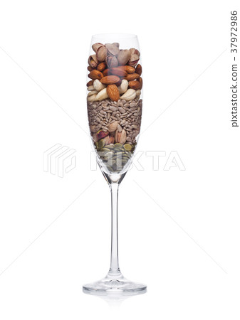 Glass with healthy organic nuts almonds and cashew Glass with healthy organic nuts almonds and cashew 37972986