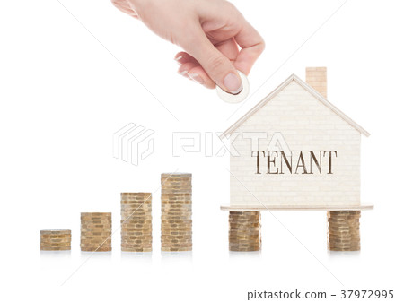 Wooden house model standing on coins and hand 37972995