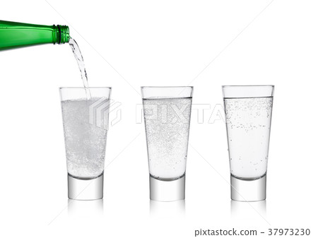 Pouring lemonade soda drink from bottle to glass Pouring lemonade soda drink from bottle to glass 37973230