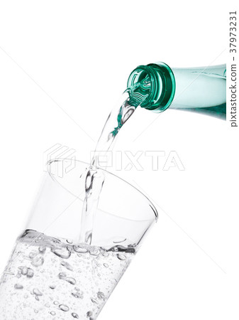 Pouring sparkling mineral water from bottle Pouring sparkling mineral water from bottle 37973231