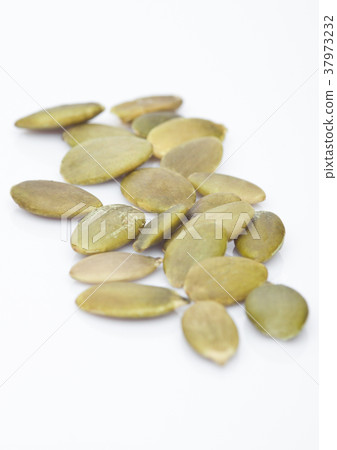 Healthy organic pumpkin seeds on white Healthy organic pumpkin seeds on white 37973232