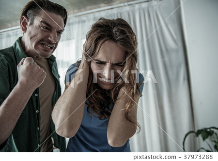 Fearful woman getting threats from aggressive man 37973288