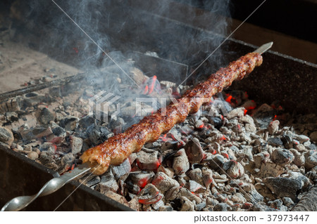 Appetizing lula kebab grilled on metal skewer. Appetizing lula kebab grilled on metal skewer. 37973447