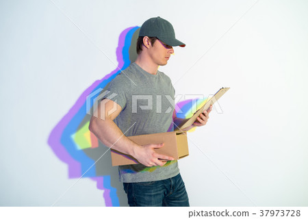 Serious postman looking at package Serious postman looking at package 37973728