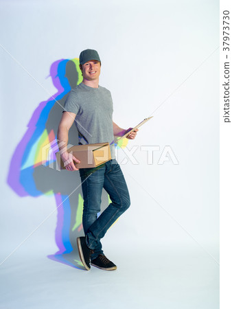 Beaming man holding package in hands 37973730