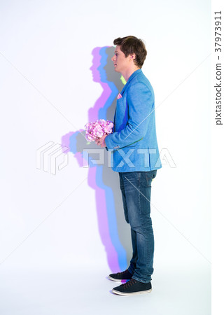 Calm man keeping bouquet of flowers Calm man keeping bouquet of flowers 37973911