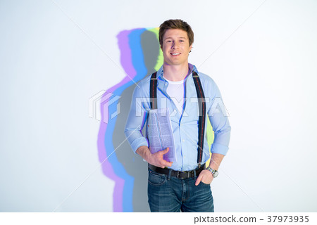 Beaming male holding article in arm 37973935