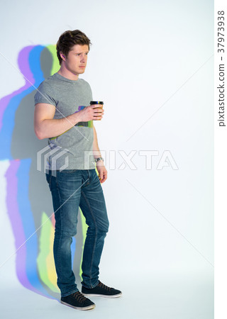 Thoughtful man tasting mug of beverage 37973938