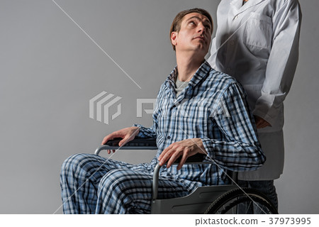 Serene disabled man staring at nurse 37973995