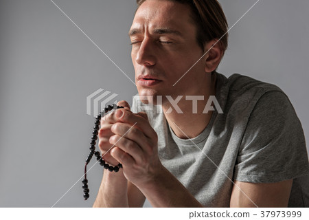 Quiet devout man focused on orison Quiet devout man focused on orison 37973999