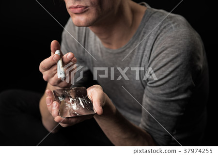 Young drug addicted sniffing coke 37974255
