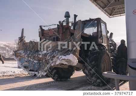 Vintage ussr tractor on petrolium station with Vintage ussr tractor on petrolium station with 37974717