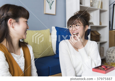 Woman eating chocolate 37975887