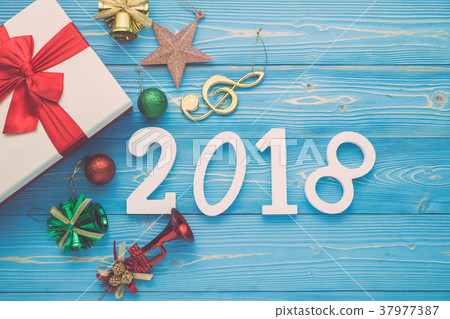 White new year or Christmas gift box with red ribbon for holiday concept on blue wooden. Top view with empty space for text and design 37977387