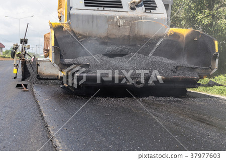 Worker operating the process of building new asphalt road on the new road construction site in Thailand 37977603