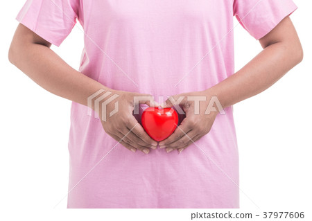 Woman holding red heart in front of her stomach isolated on white Woman holding red heart in front of her stomach isolated on white 37977606