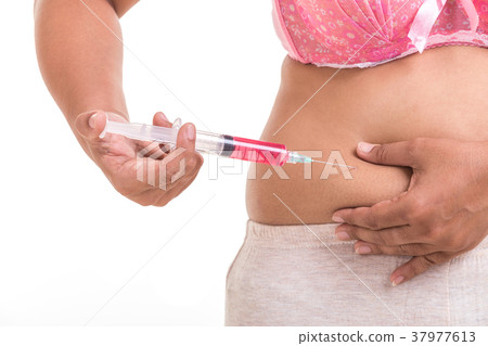 Fat woman holding syringe and inject red medicine to her belly isolated on white Fat woman holding syringe and inject red medicine to her belly isolated on white 37977613