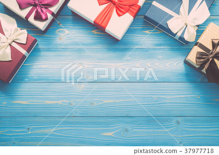 White new year or Christmas gift box with red ribbon for holiday concept on blue wooden. Top view with empty space for text and design 37977718