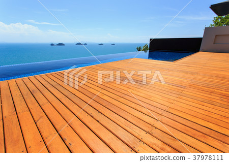 Wooden flooring beside the pool 37978111