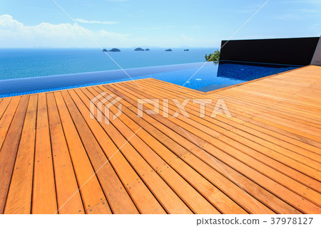 Wooden flooring beside the pool 37978127