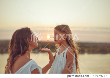 Family. Mother and daughter. Sunset 37979216