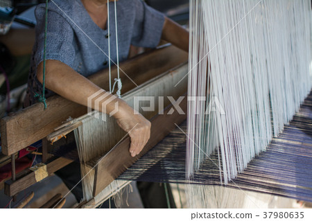 Woman weaving silk in traditional way Woman weaving silk in traditional way 37980635