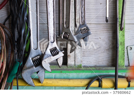Old hand tools hanging on wall in workshop Old hand tools hanging on wall in workshop 37980662