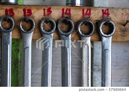 Old hand tools hanging on wall in workshop Old hand tools hanging on wall in workshop 37980664