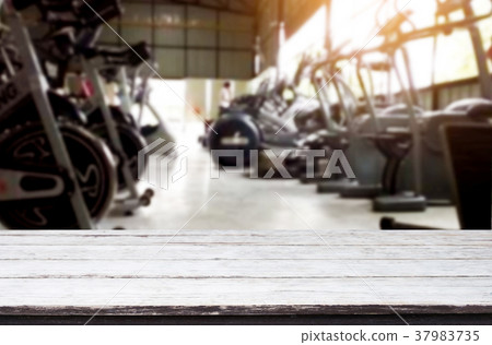 Wooden table on blurred background of fitness gym interior of mo 37983735