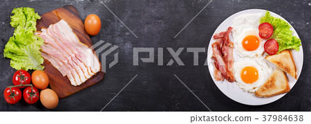 fried eggs with bacon and ingredients for cooking fried eggs with bacon and ingredients for cooking 37984638