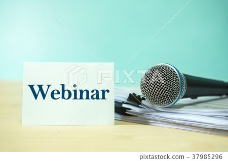 Microphone on  document with Webinar text 37985296