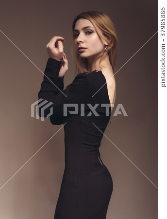 Beautiful young woman in black dress Beautiful young woman in black dress 37985886