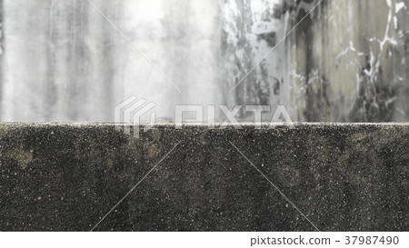 The old cement wall separates the empty house  37987490