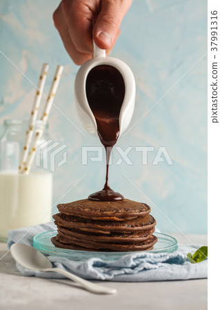 Chocolate pancakes with chocolate syrup Chocolate pancakes with chocolate syrup 37991316