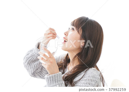 Woman taking powder medicine 37992259