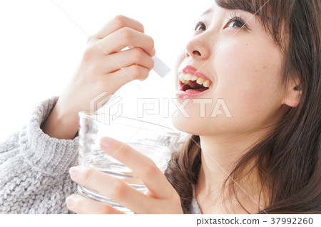 Woman taking powder medicine 37992260