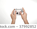 Hands are holding white gamepad isolated against a 37992852