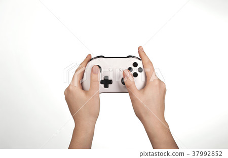 Hands are holding white gamepad isolated against a 37992852