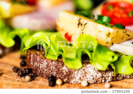 Sandwiches with cheese, turkey, lettuce and tomato 37993209