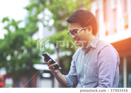 Handsome Business man in an using telephone glad 37993456