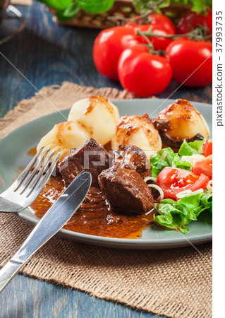Pork meat stew served with potatoes Pork meat stew served with potatoes 37993735