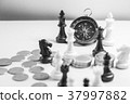 Chess and navigation compass on chessboard in conc 37997882