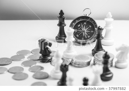 Chess and navigation compass on chessboard in conc Chess and navigation compass on chessboard in conc 37997882