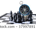 Chess and navigation compass on chessboard in conc 37997891