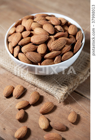 Almond snack fruit in white bowl on wooden Almond snack fruit in white bowl on wooden 37998013