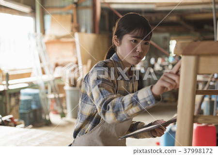 Furniture maker young woman 37998172