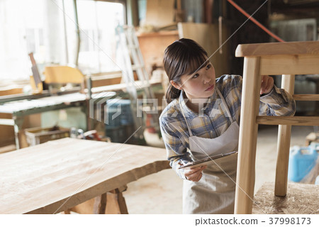 Furniture maker young woman 37998173